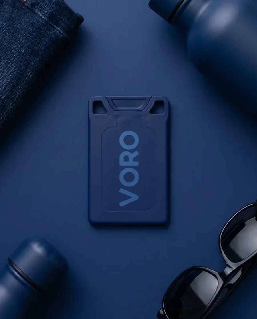 The navy VORO card on a navy field with denim, bottles, and sunglasses.