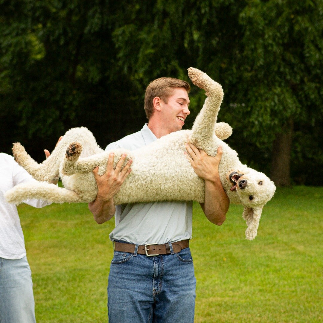 Nick, VORO's founder, laughing while holding his dog outside.