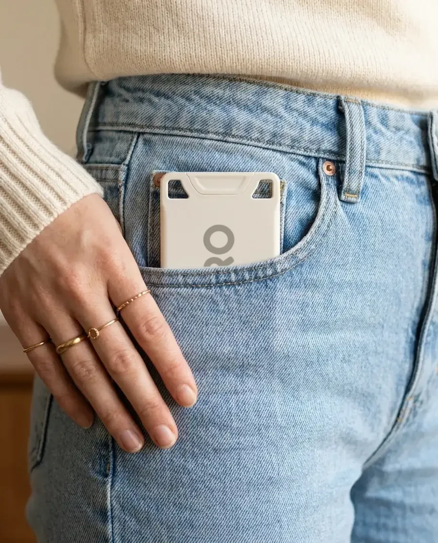 The white VORO card sitting flat in the front pocket of light jeans.