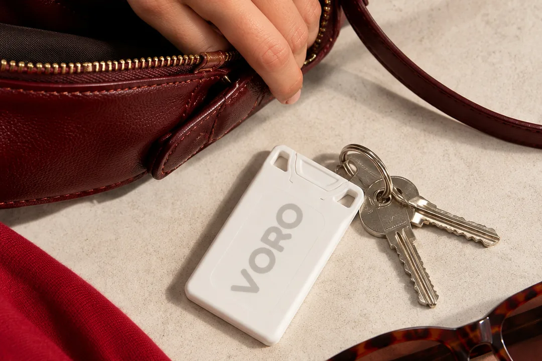 VORO on her keys, set down next to her bag and sunglasses.