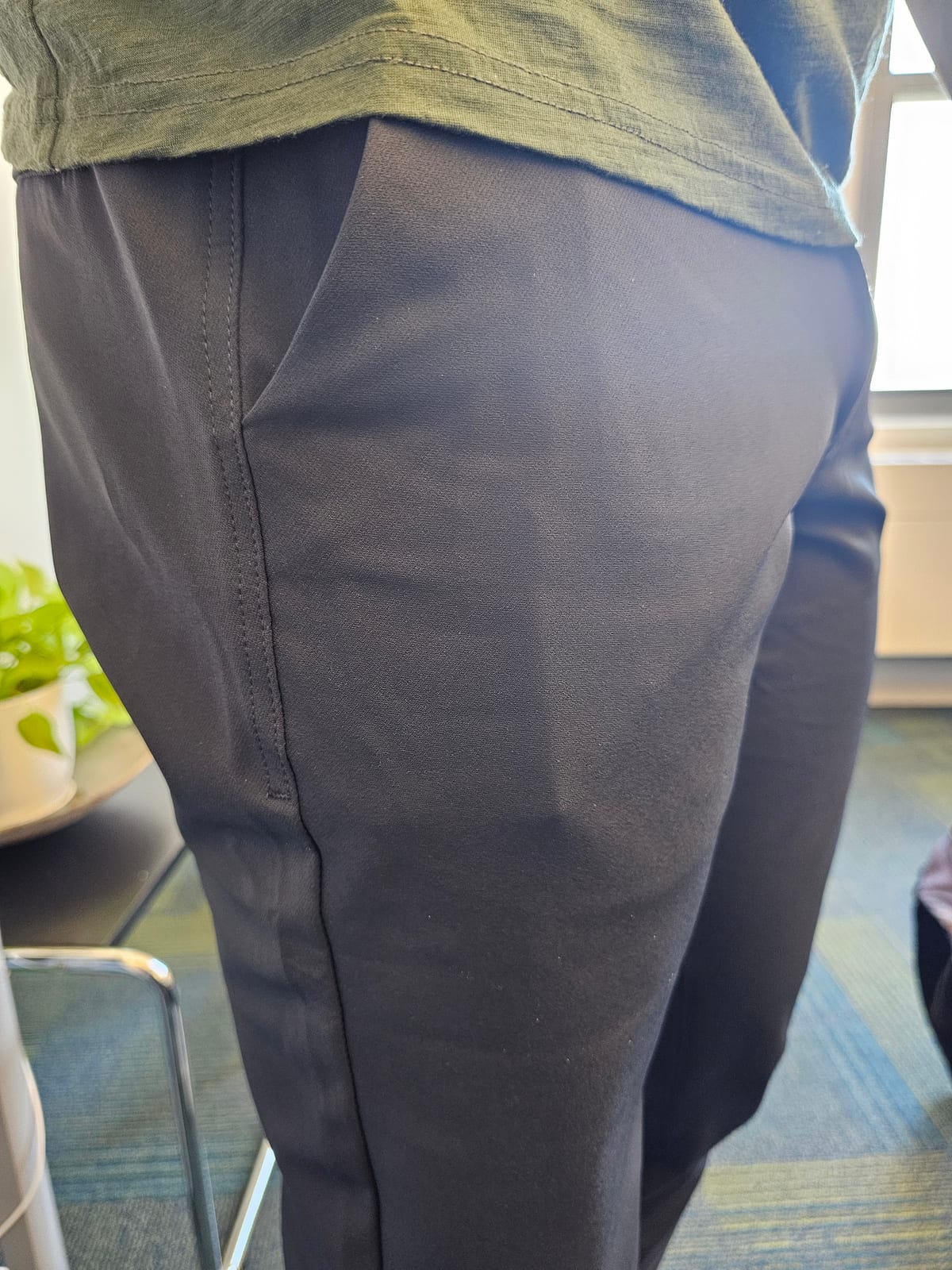 A flat VORO carried in a front pants pocket, the pocket stays smooth with no bulge.
