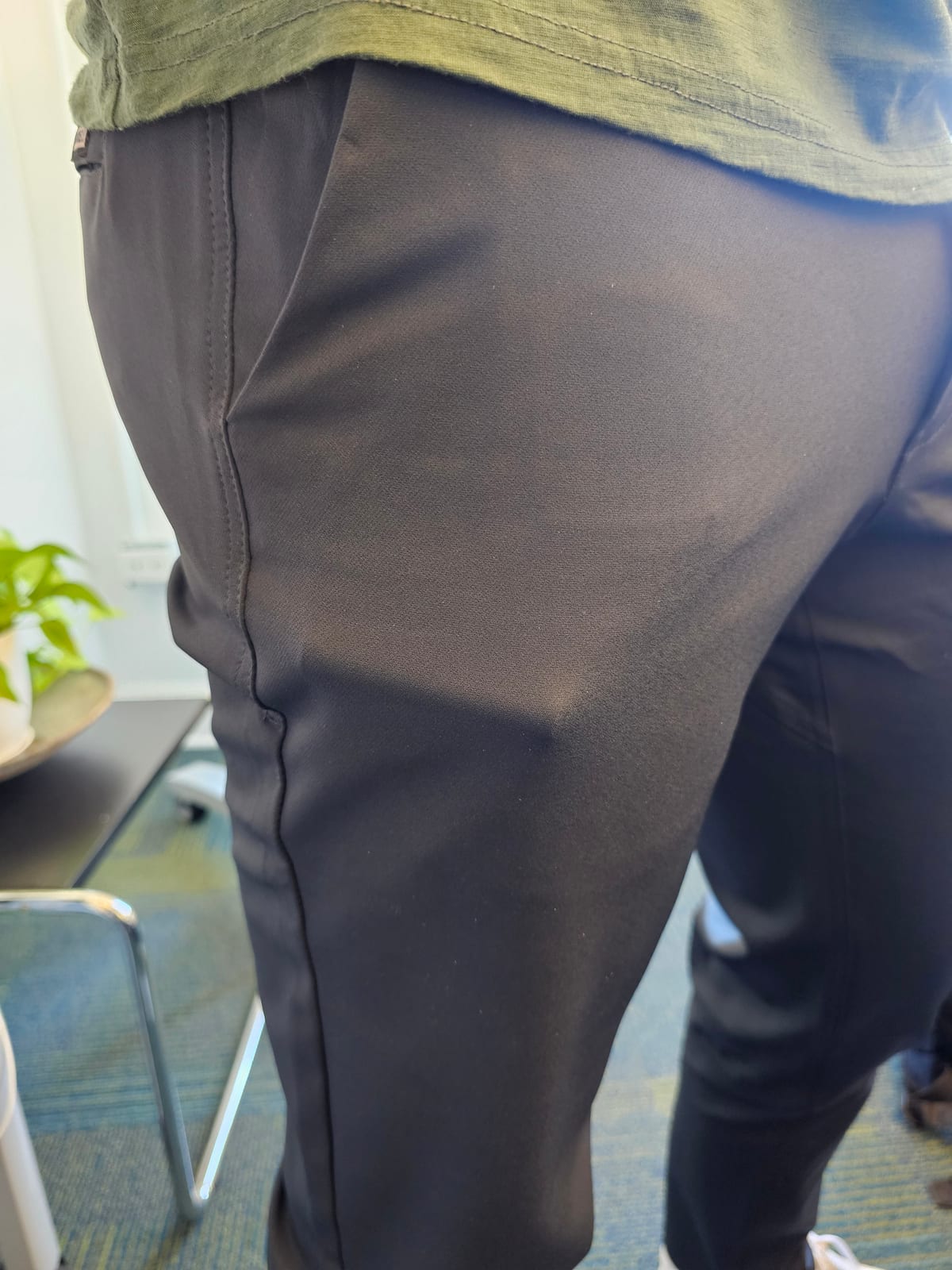 A round lip balm tube creating a big bulge in a front pants pocket.